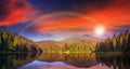 Pine forest and lake near the mountain early at sunset Royalty Free Stock Photo