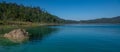 Pine forests in front of Lake Tziscao with a blue sky in the background, Montebello Lakes, Mexican Royalty Free Stock Photo