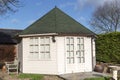 A pine garden office situated in the corner of a country garden