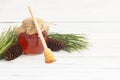 Pine honey in jar or bowl with honey stick and pine cones on wooden rustic table Royalty Free Stock Photo