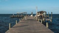 PINE ISLAND, FLORIDA - JAN 17, 2020. Pelican and men fishing on Bokeelia Pier Royalty Free Stock Photo