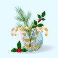 Pine, mistletoe branches and shiny candy canes in glass ball vase