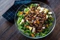 Pine Nut Salad with Walnut, Pear, Dried Apricot, Arugula or Rucola Leaves in Glass Bowl Royalty Free Stock Photo