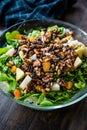 Pine Nut Salad with Walnut, Pear, Dried Apricot, Arugula or Rucola Leaves in Glass Bowl Royalty Free Stock Photo