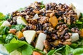 Pine Nut Salad with Walnut, Pear, Dried Apricot, Arugula or Rucola Leaves in Glass Bowl Royalty Free Stock Photo