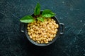 Pine nuts in a black stone bowl. Royalty Free Stock Photo