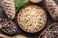 Pine nuts in the bowl and pine nut cones on the wooden table. Organic food Royalty Free Stock Photo