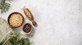 Pine nuts in a bowl and wooden scoop on a napkin on a light texture background with branches of pine needles. The concept of a Royalty Free Stock Photo