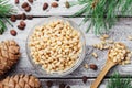 Pine nuts and cedar cones on vintage wooden table top view. Organic and healthy superfood. Royalty Free Stock Photo