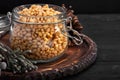 Pine nuts in a glass dish on a dark background with nuts scattered around Royalty Free Stock Photo