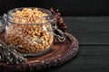 Pine nuts in a glass dish on a dark background with nuts scattered around Royalty Free Stock Photo