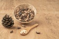 Pine nuts, kernels and cone on wooden table Royalty Free Stock Photo