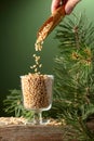 Pine nuts is poured in a glass bowl