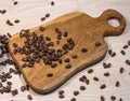 Pine nuts scattered on the table and on a wooden cutting Board.