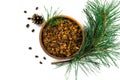 Pine nuts shell in the bowl, cedar branch, nuts and cones on white background