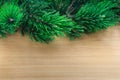 Pine tree branches over wooden background