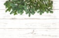 Pine tree branches on wooden texture. Christmas decoration Royalty Free Stock Photo