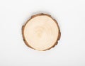 Pine tree cross-section with annual rings on white background. Lumber piece close-up, top view, isolated.