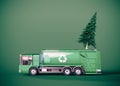 Pine tree with recycling truck on green background with copy space. Recycle Christmas tree concept.