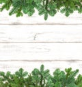 Pine tree twigs on wooden background. Winter holidays