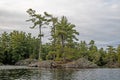 Pine Trees Grown From Small Rock Island On Canadian Wilderness Lake