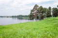 Pine trees on the lake bank opposite Ferapontovo monastery, Russia. Summer day, clouds in blue sky Royalty Free Stock Photo