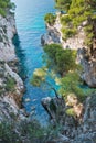 Pine trees on a rock over crystal clear turquoise water near Cape Amarandos at Skopelos island Royalty Free Stock Photo