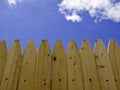 Pine Wood Fence with Blue Sky and Clouds Royalty Free Stock Photo
