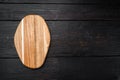 Pine wooden cutting board, on black wooden table background, top view flat lay , with copy space for text or your product Royalty Free Stock Photo