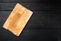 Pine wooden cutting board, on black wooden table background, top view flat lay , with copy space for text or your product Royalty Free Stock Photo