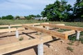 Pine wooden frame house foundation on concrete piles, construction site