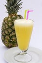 Pineaple juice with fresh pineapple isolated on white. Picture taken in Peru.