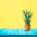 Pineapple on blue wood on yellow background.For montage product display or design keyvisual