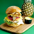 pineapple chicken burger on green background