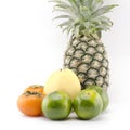 Pineapple chinese pear persimon and green orange on whi Royalty Free Stock Photo