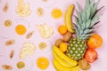 Pineapple. coconut, orange, bananas and dry fruit chps on pink background Royalty Free Stock Photo