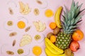 Pineapple. coconut, orange, bananas and dry fruit chps on pink background Royalty Free Stock Photo