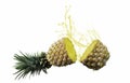 Pineapple, cut in half in mid-air, with water or splash. Ripe fruit is not peeled. on a white background Royalty Free Stock Photo
