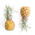 Pineapple cut in half on white background. Two half baby pineapple isolated on whitt and juicy.e background. The flesh Royalty Free Stock Photo