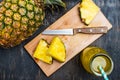Pineapple and pineapple slices on a cutting board top view Royalty Free Stock Photo