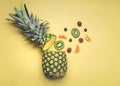 Pineapple with different fruits, oranges, kiwis, grapes and blueberries Royalty Free Stock Photo