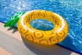Pineapple float ring at blue swimming pool Royalty Free Stock Photo