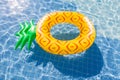 Pineapple float ring on the blue swimming pool Royalty Free Stock Photo