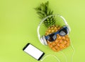 Pineapple fruit with headphones top view