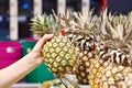 Pineapple in hand of buyer in shop