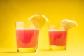 Pineapple juice in glass closeup near sliced fruit with spash and dripping liqid for summer vibes