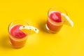 Pineapple juice in glass closeup near sliced fruit with spash and dripping liqid for summer vibes