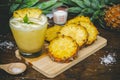 Pineapple juice and pineapple slices cut into pieces on a wooden table. Healthy wood fiber helps to reduce food. Pineapple juice Royalty Free Stock Photo