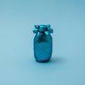 Pineapple made of turquoise ribbon for gift wrapping for Christmas, New year, birthday or anniversary on blue background. Minimal