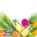 Pineapple, mango and dragon fruits with palm leaf on white background. Flat lay, top view. Tropical food concept. Royalty Free Stock Photo